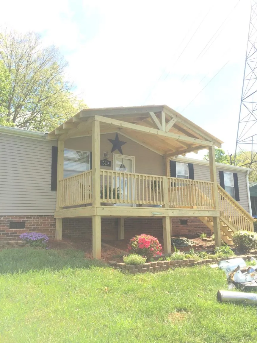 New gabled porch roof and deck railing added to a ranch home in West Hyannisport